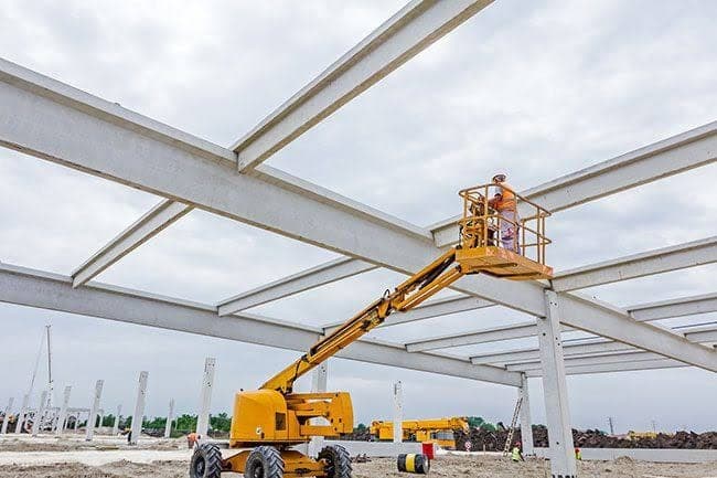 A steel structure being erected from an access platform.